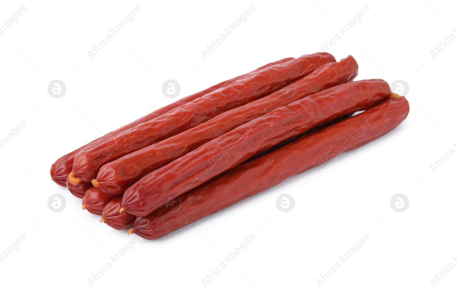 Photo of Many delicious smoked sausages isolated on white