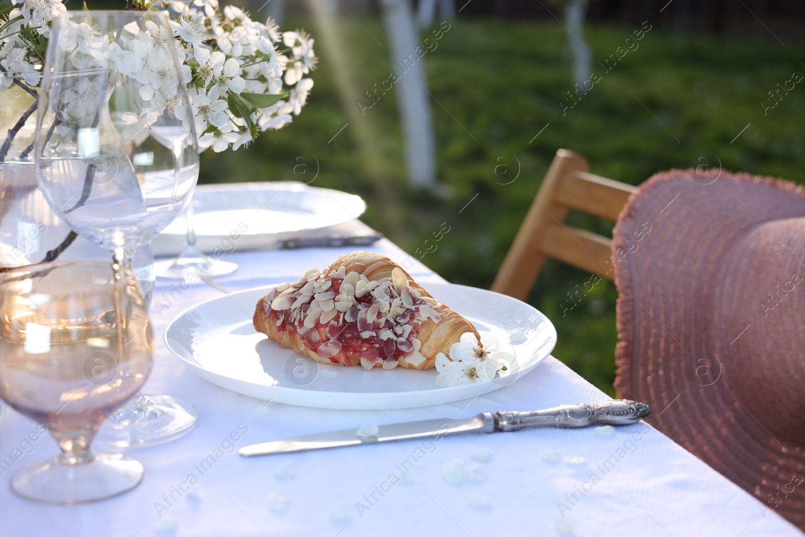 Photo of Stylish table setting with beautiful spring flowers in garden