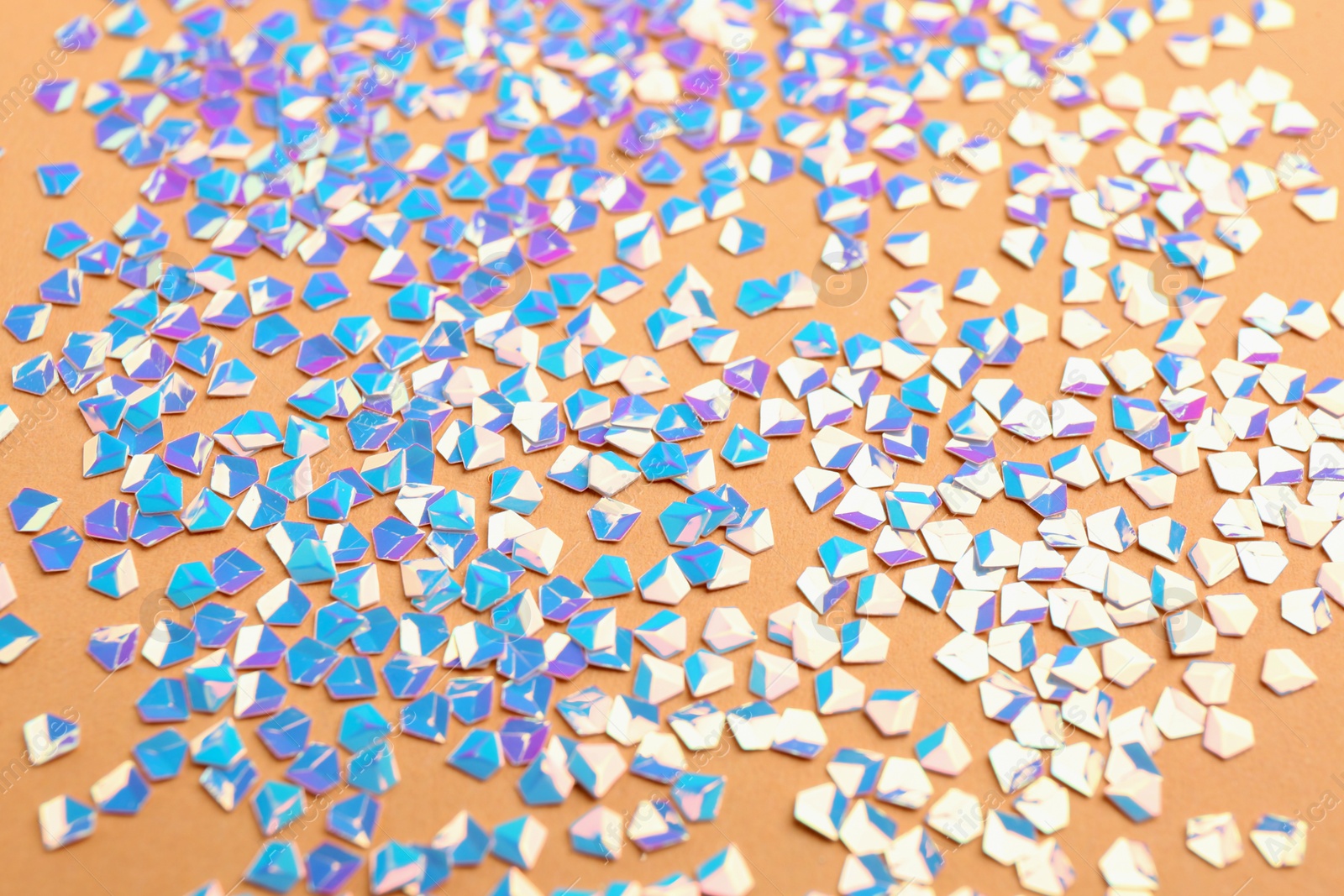 Photo of Shiny bright light blue glitter on beige background