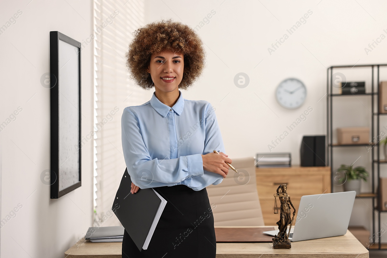 Photo of Happy notary with clipboard and pen in office