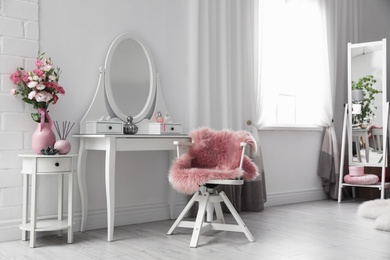 Stylish room interior with white dressing table