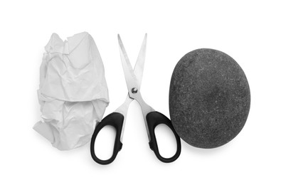 Photo of Rock, crumpled paper and scissors on white background, top view