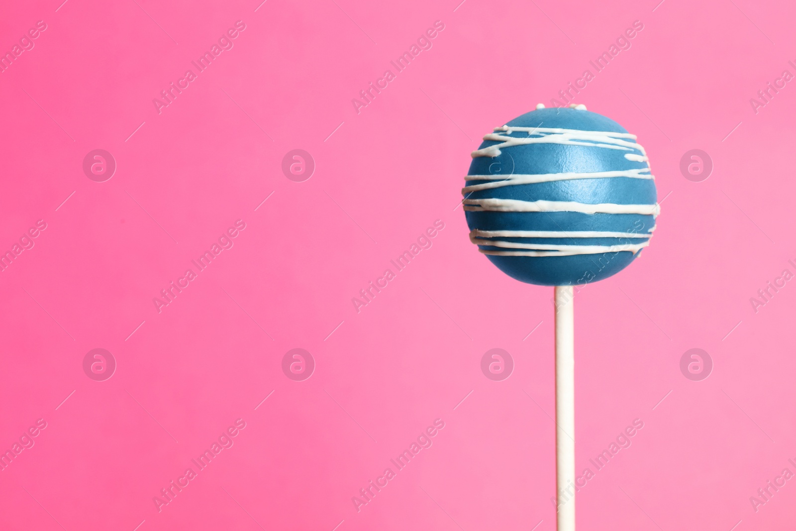 Photo of Bright delicious cake pop on color background. Space for text