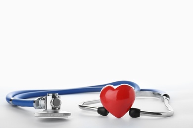 Stethoscope and red heart on white background