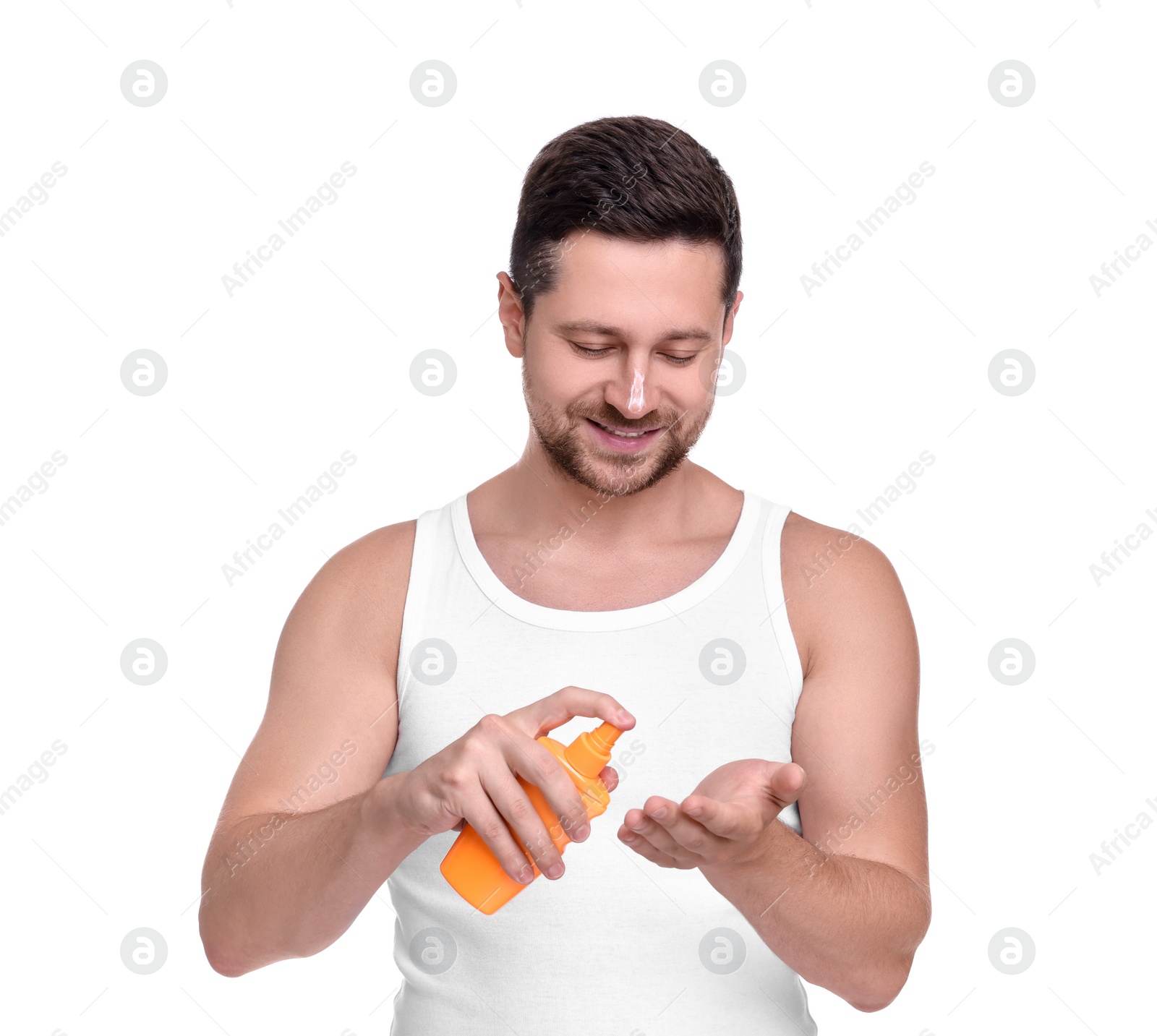 Photo of Handsome man with bottle of sun protection cream on white background