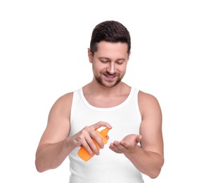 Handsome man with bottle of sun protection cream on white background