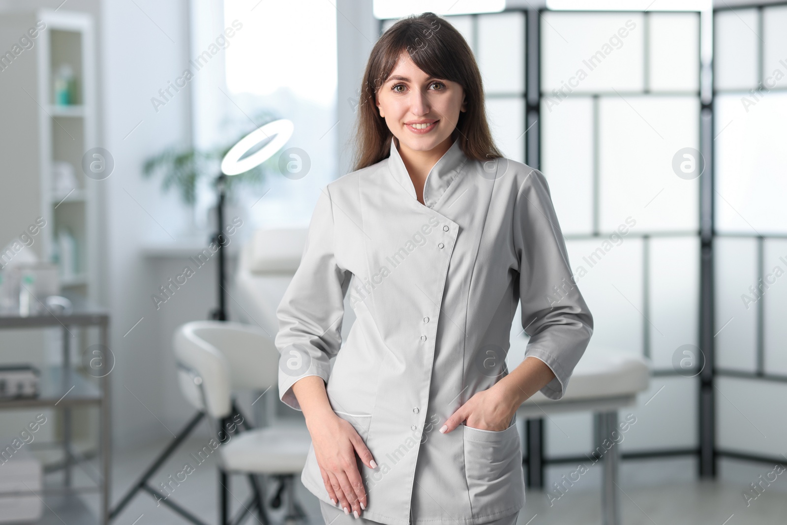 Photo of Cosmetologist in medical uniform in modern clinic