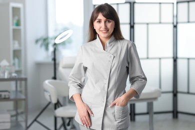 Photo of Cosmetologist in medical uniform in modern clinic