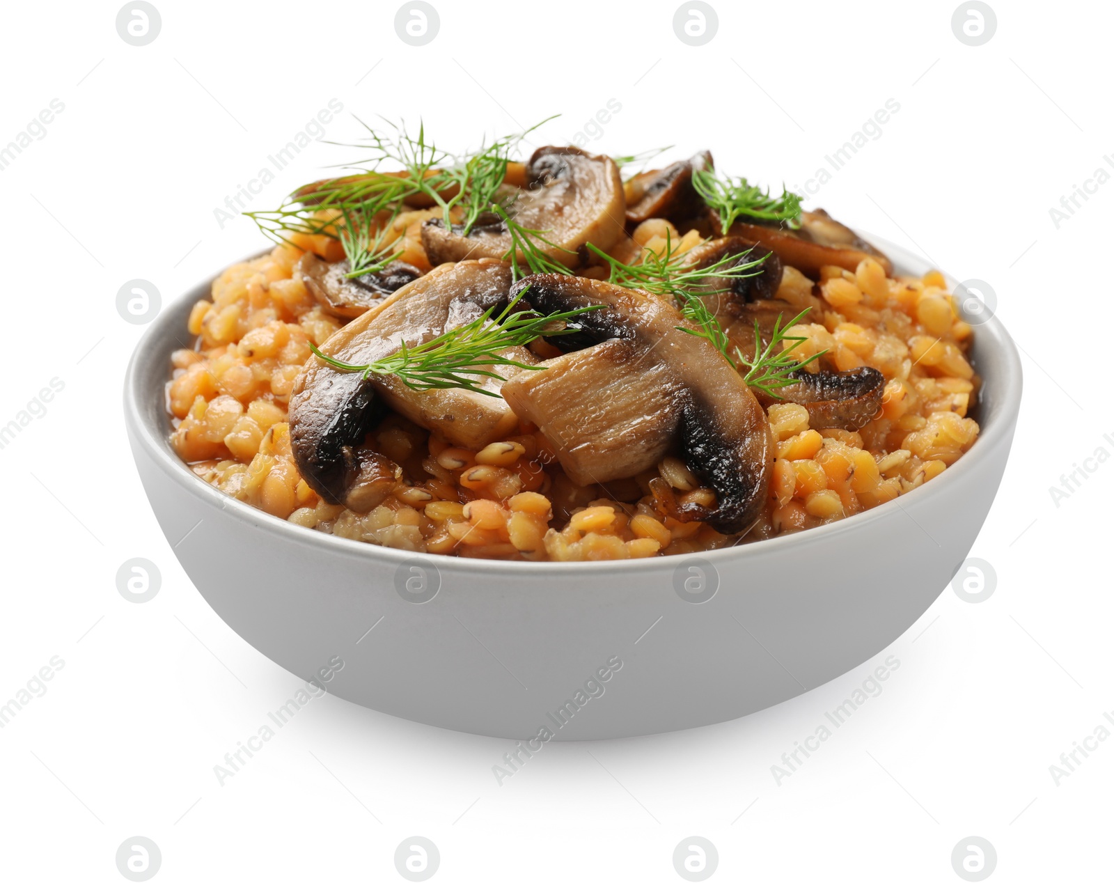 Photo of Delicious red lentils with mushrooms and dill in bowl isolated on white