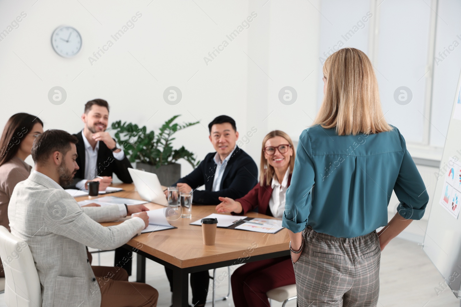 Photo of Businesswoman having meeting with her employees in office