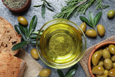 Photo of Flat lay composition with olive oil on grey table, flat lay