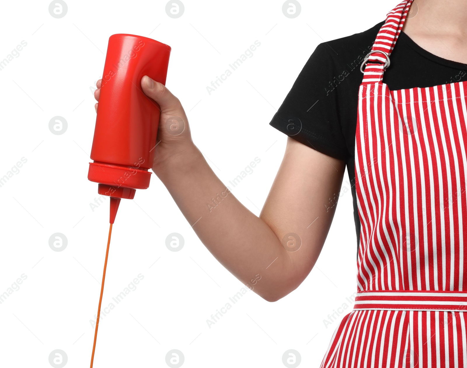 Photo of Woman pouring tasty ketchup from bottle on white background, closeup