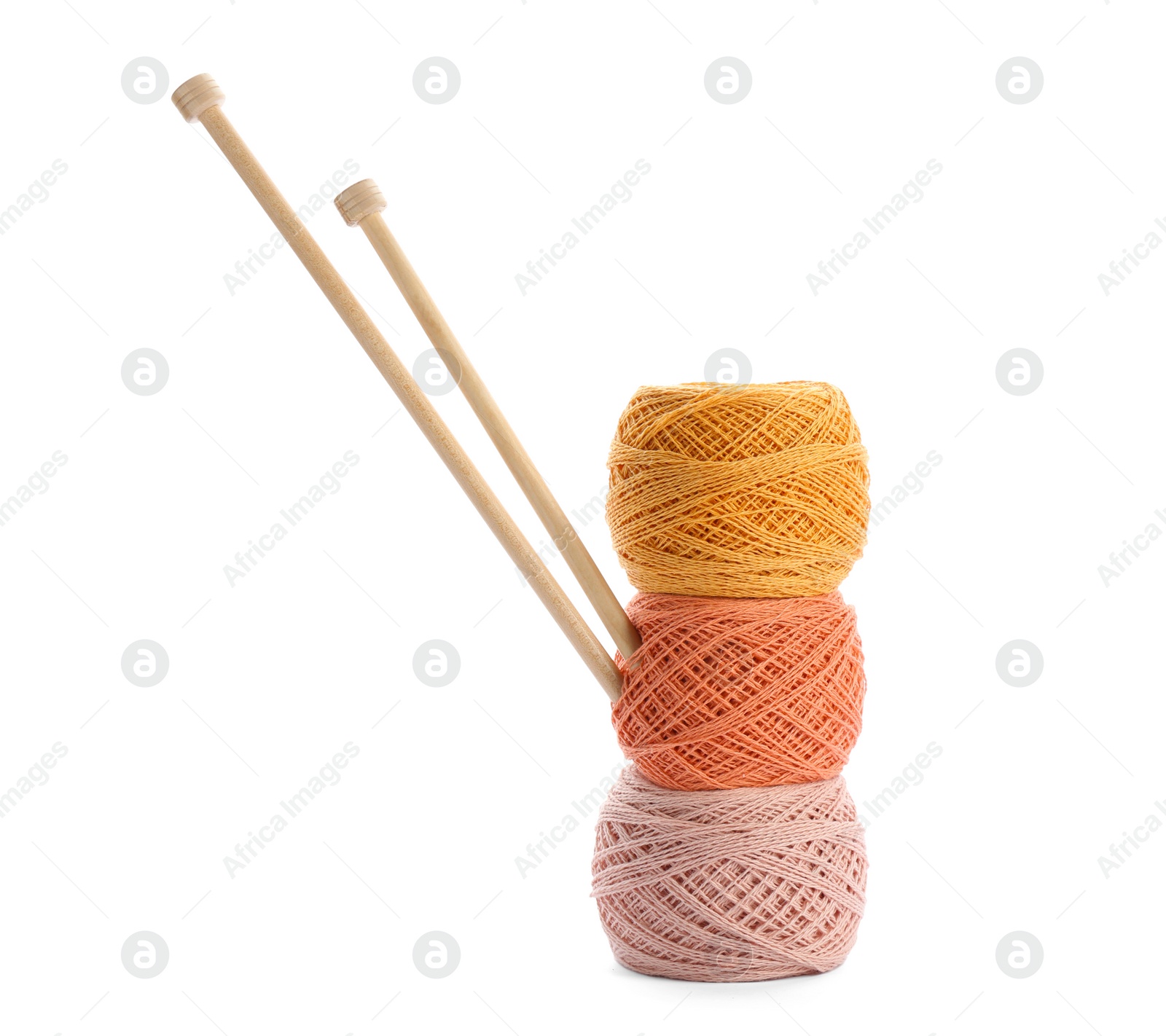 Photo of Clews of colorful threads with knitting pins on white background