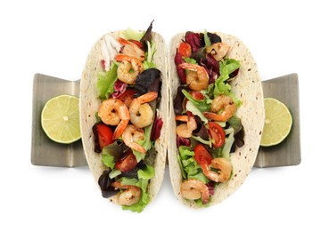 Photo of Delicious tacos with shrimps and lime on white background, top view
