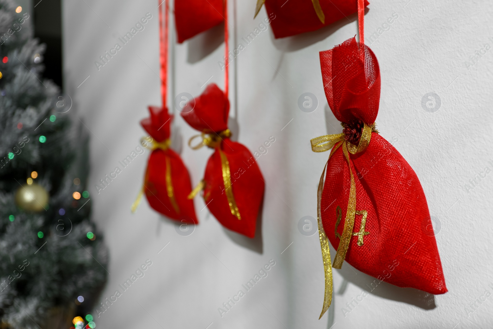 Photo of New Year advent calendar hanging on white wall indoors