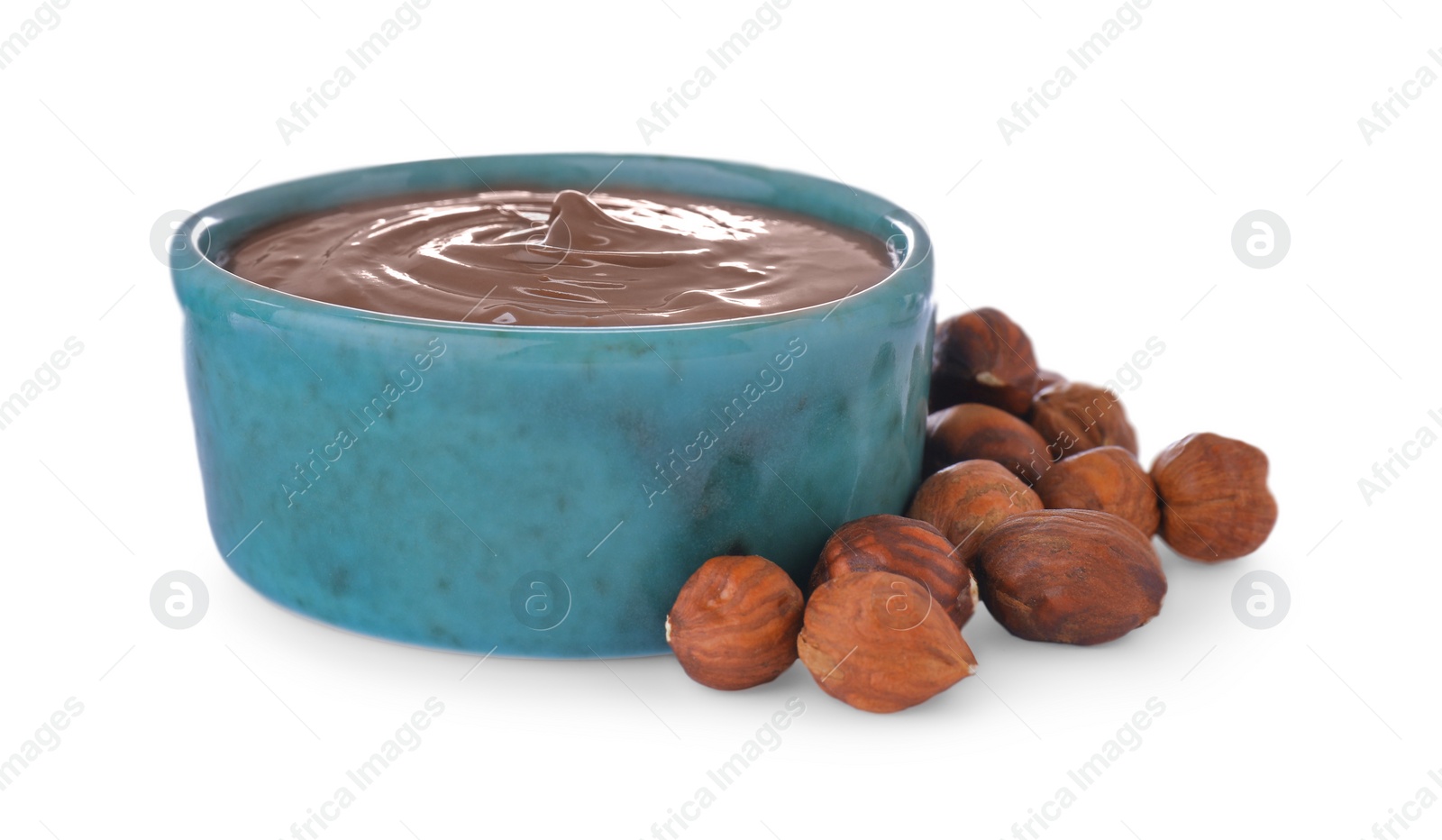 Photo of Bowl with tasty chocolate paste and nuts isolated on white