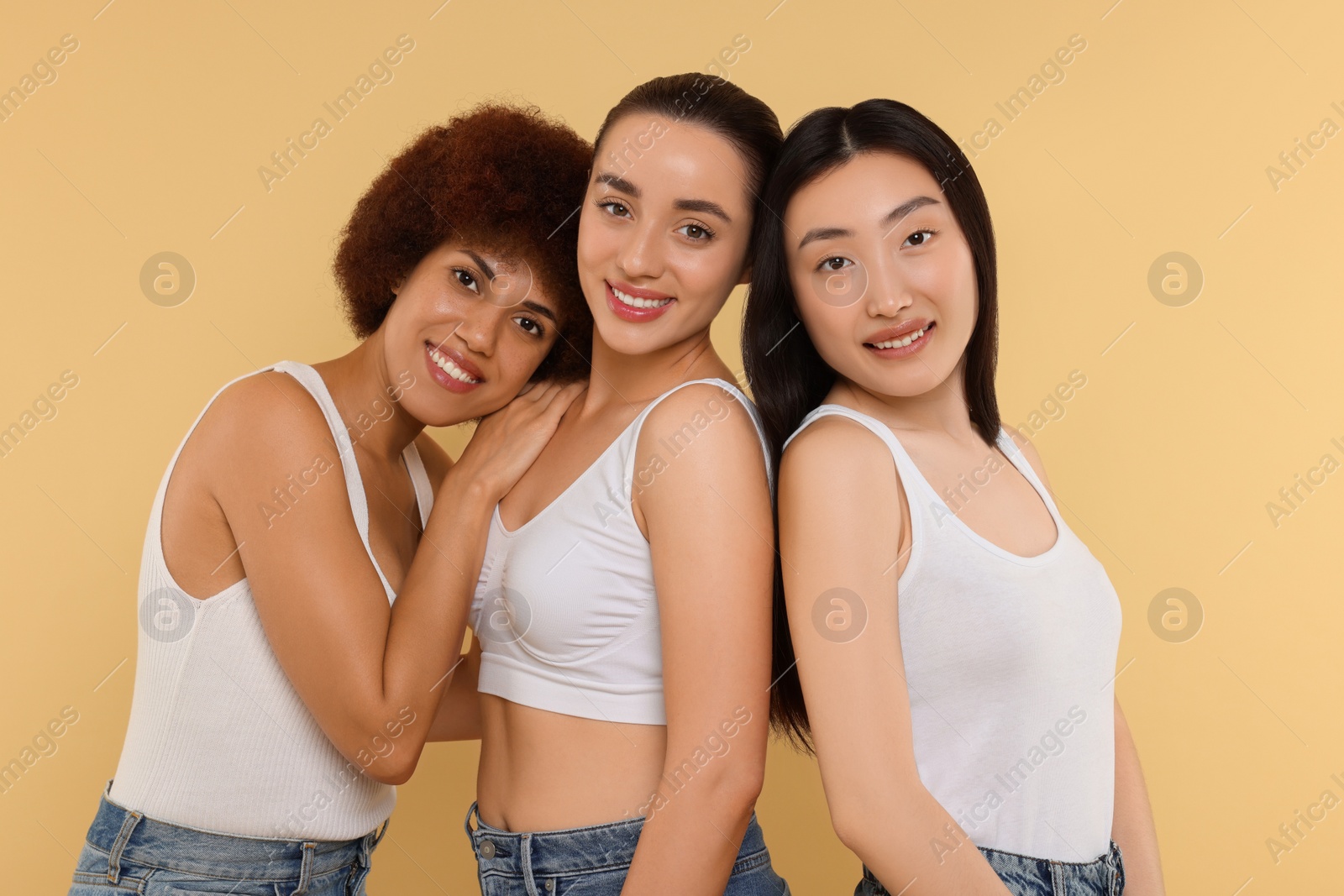 Photo of Portrait of beautiful young women on beige background