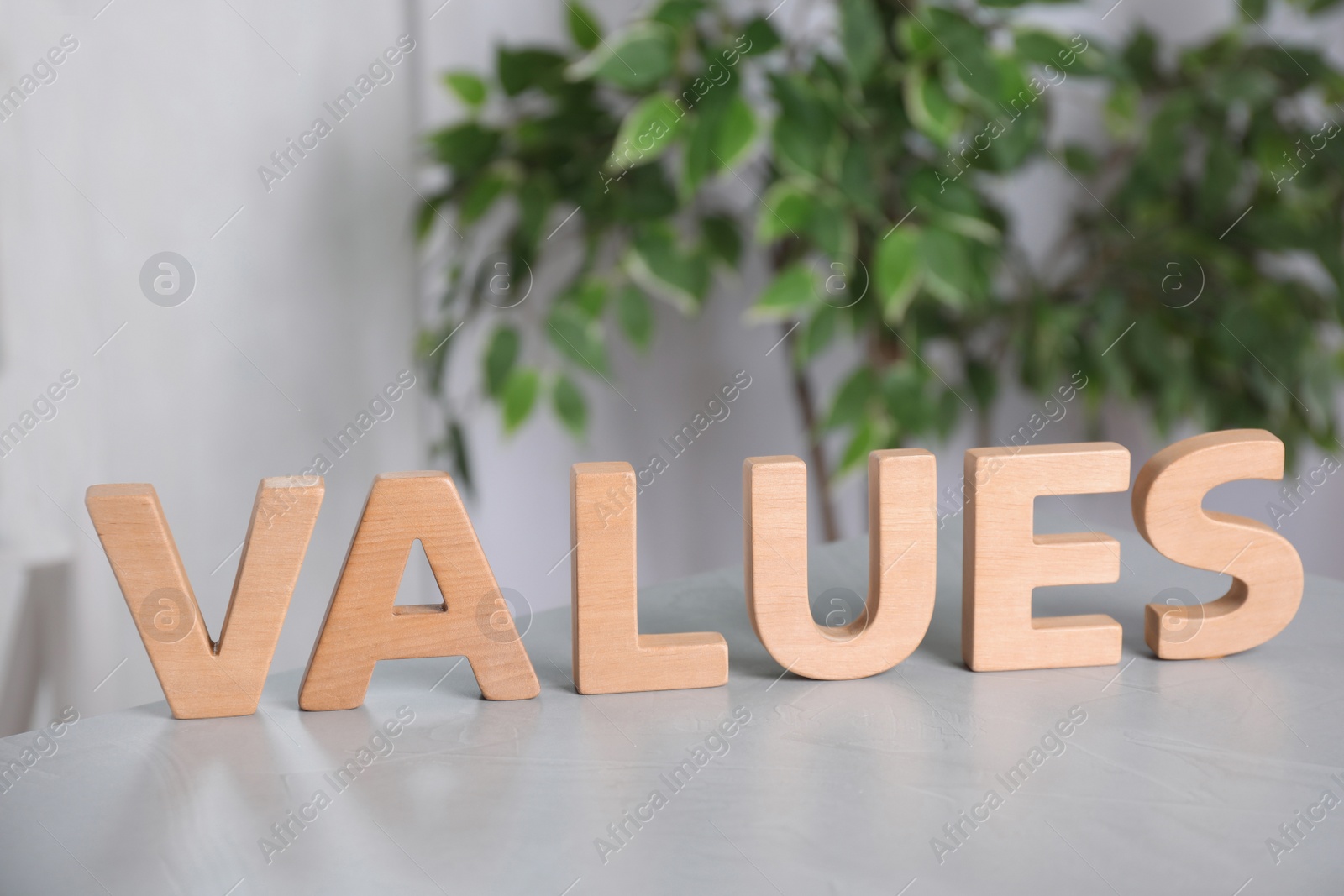 Photo of Word VALUES made of wooden letters on light table