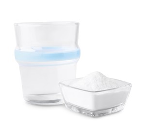 Photo of Bowl of sweet fructose powder and glass with syrup on white background