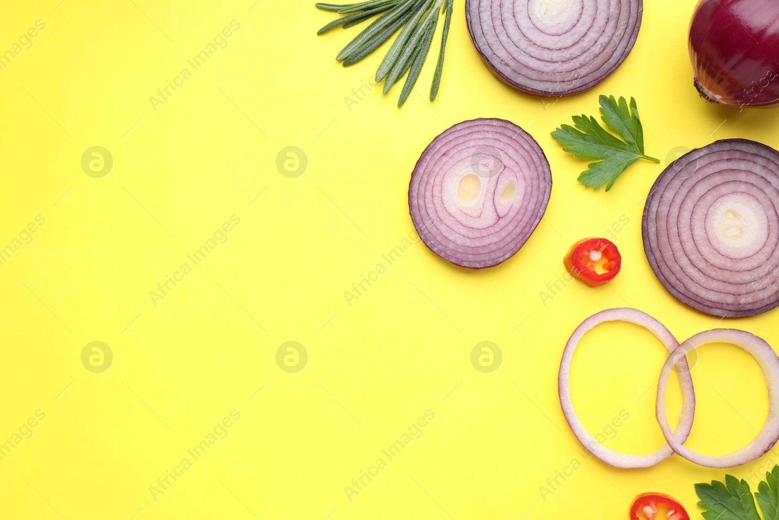 Photo of Flat lay composition with onion and spices on yellow background. Space for text