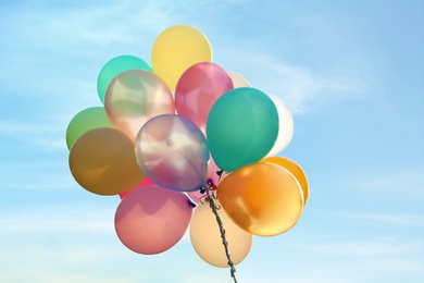 Image of Bunch of bright balloons in blue sky