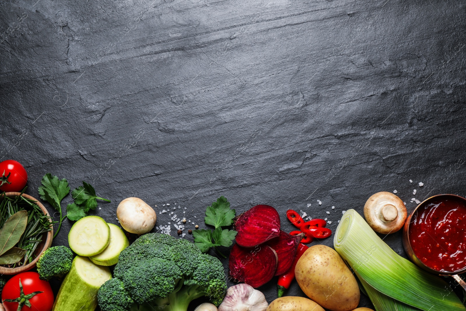 Photo of Flat lay composition with fresh products on grey table, space for text. Healthy cooking