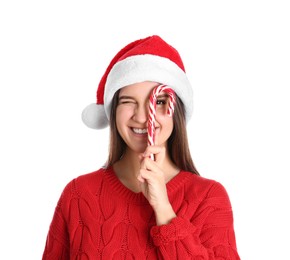 Pretty woman in Santa hat and red sweater holding candy cane on white background