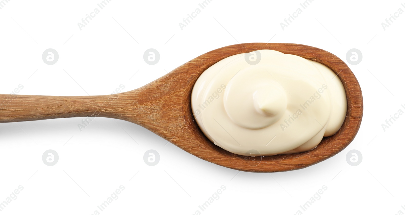 Photo of Natural yogurt in wooden spoon isolated on white, top view