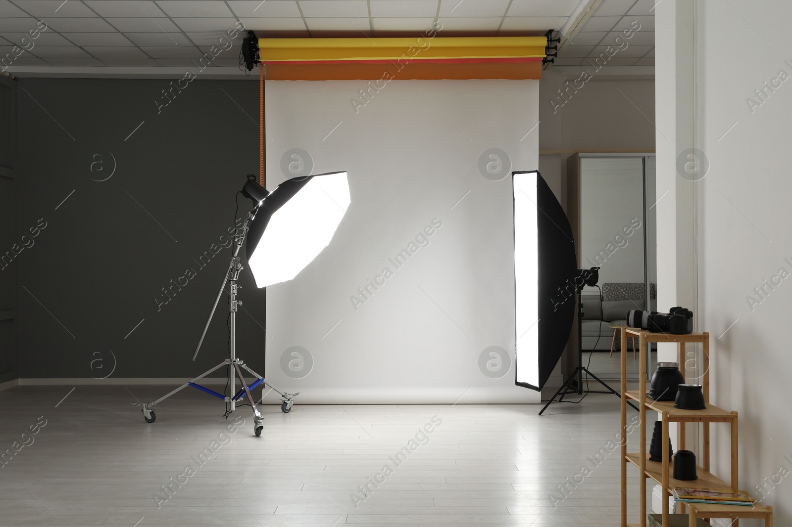 Photo of White photo background and professional lighting equipment in studio