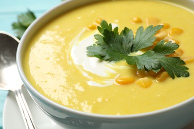 Delicious creamy corn soup on table, closeup