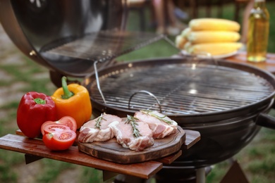 Photo of Modern barbecue grill with fresh products outdoors