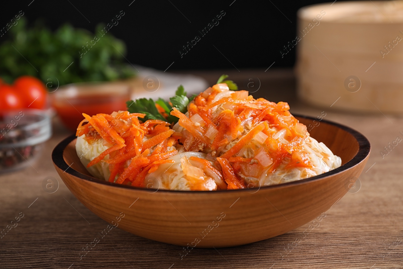 Photo of Delicious cabbage rolls on wooden table, closeup