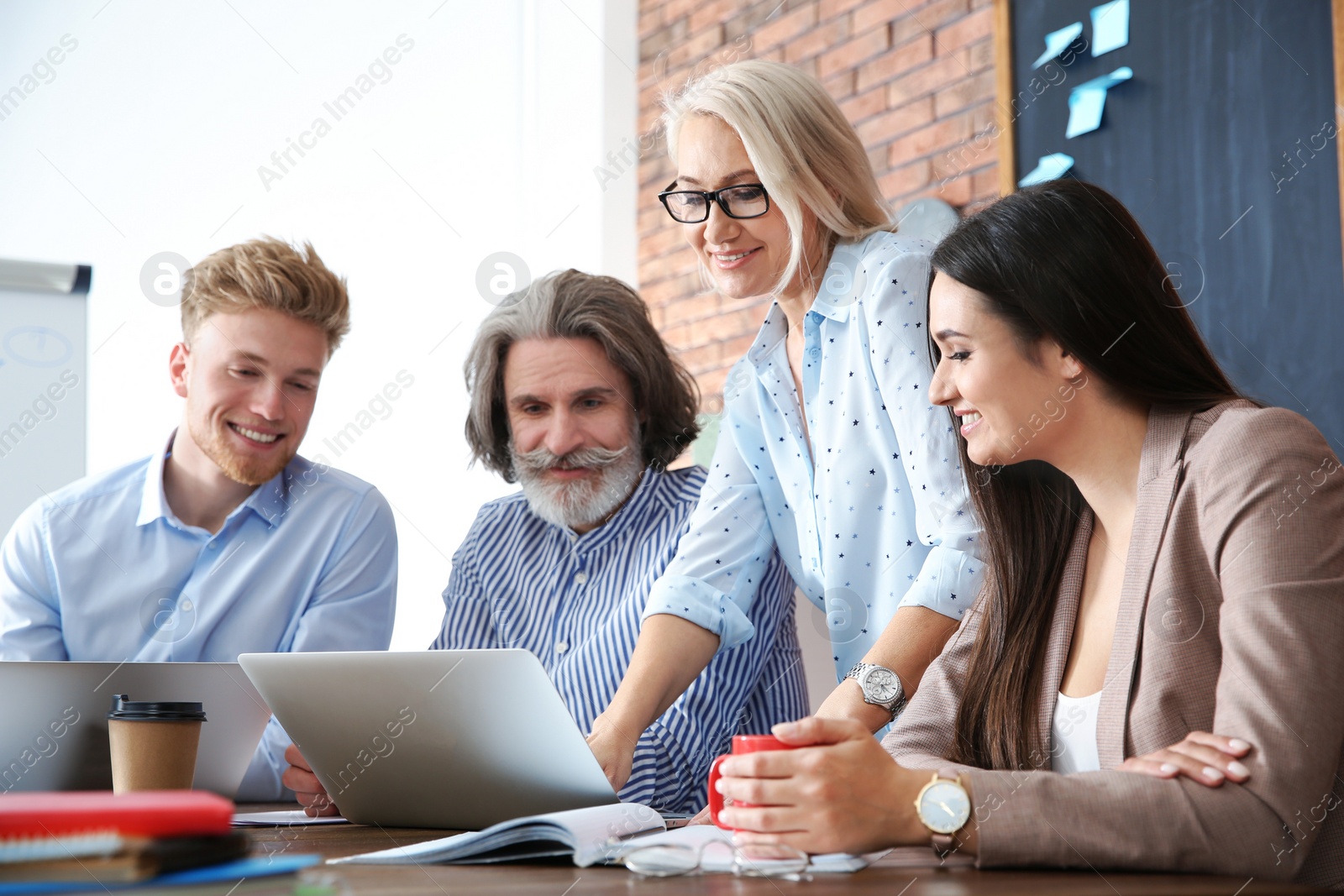 Photo of Business people discussing work matters at table in office. Professional communication