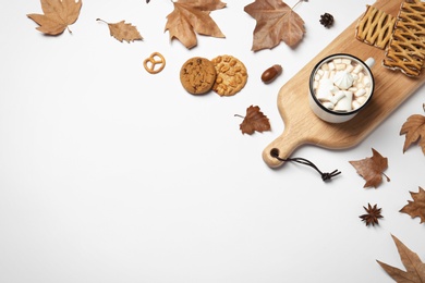 Flat lay composition with hot cozy drink and autumn leaves on white background. Space for text