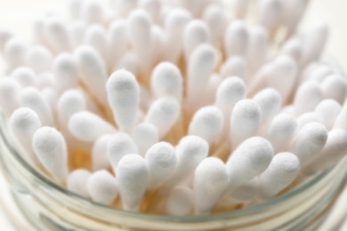 Photo of Many cotton buds in glass jar, closeup