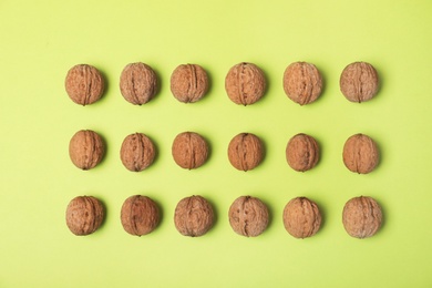 Photo of Group of walnuts on color background, flat lay