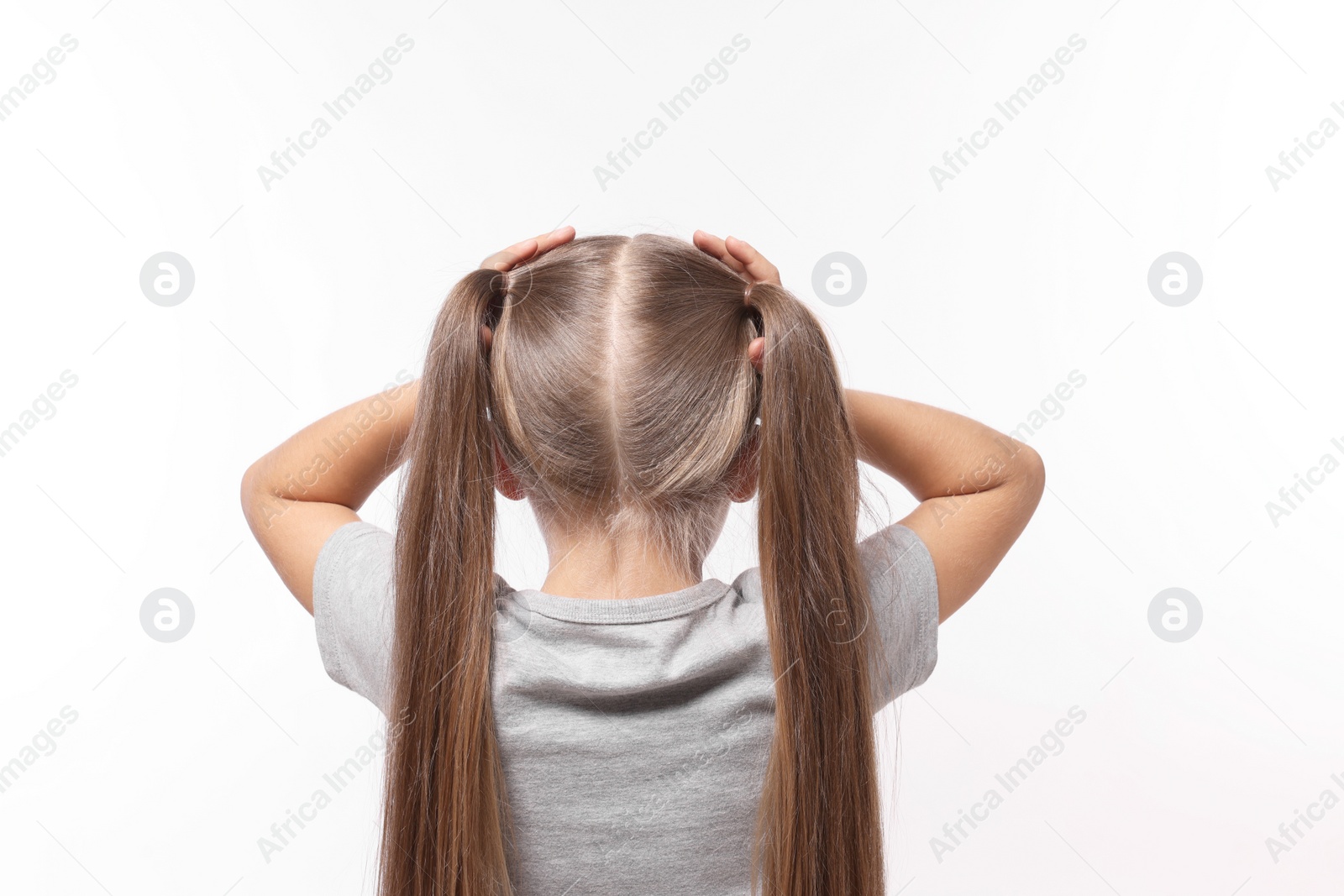 Photo of Dyslexia problem. Girl covering head with hands on white background, back view