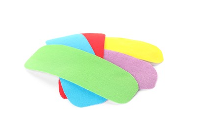 Bright kinesio tape pieces on white background