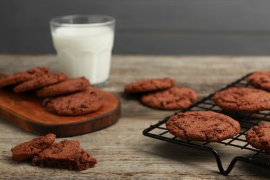 Photo of Delicious chocolate chip cookies on wooden table, closeup