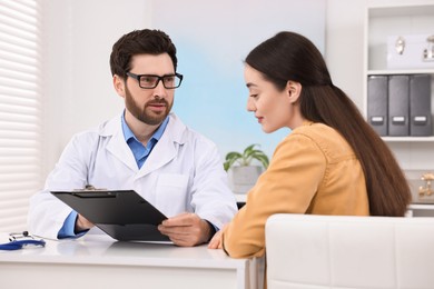 Doctor consulting patient during appointment in clinic