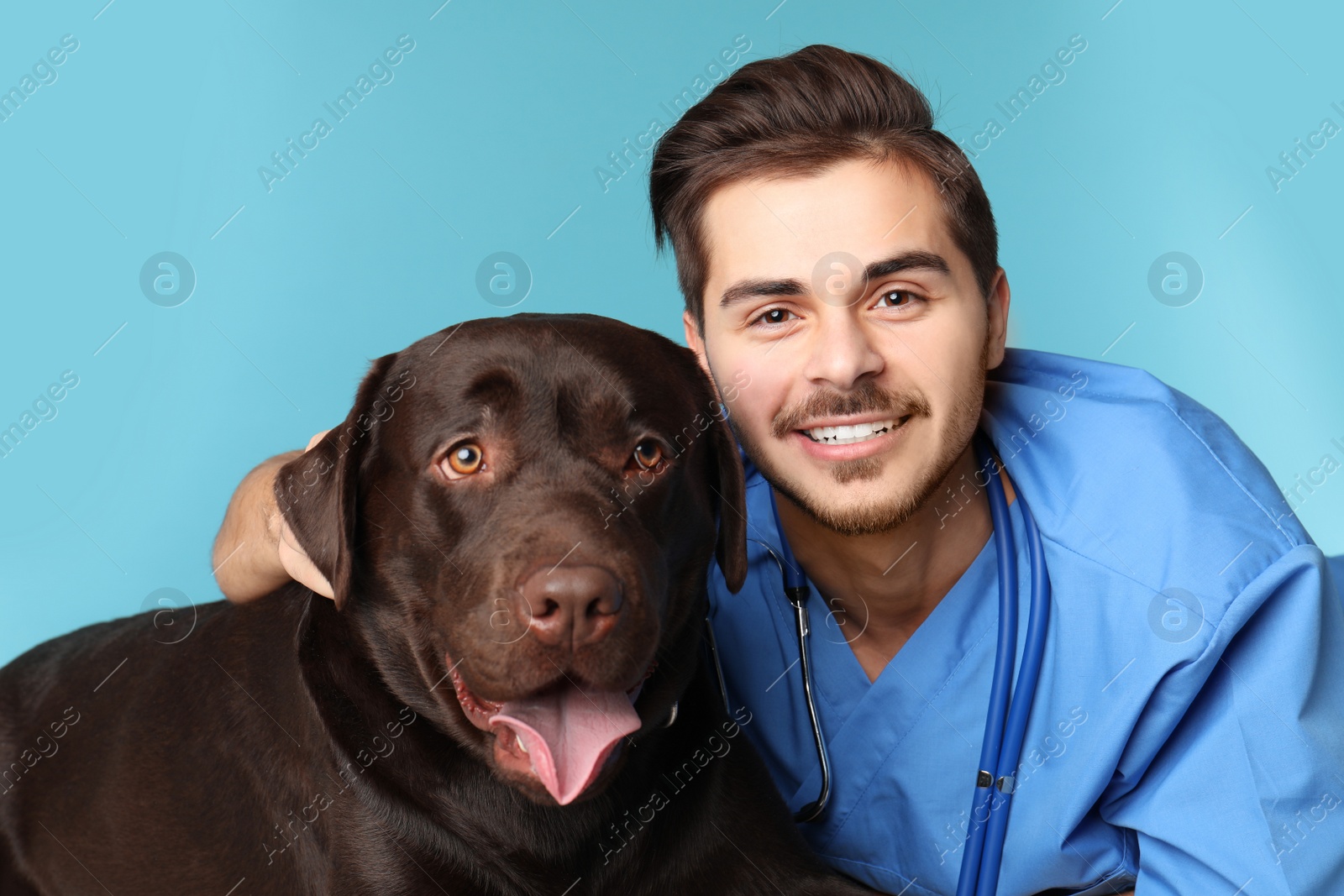 Photo of Veterinarian doc with dog on color background