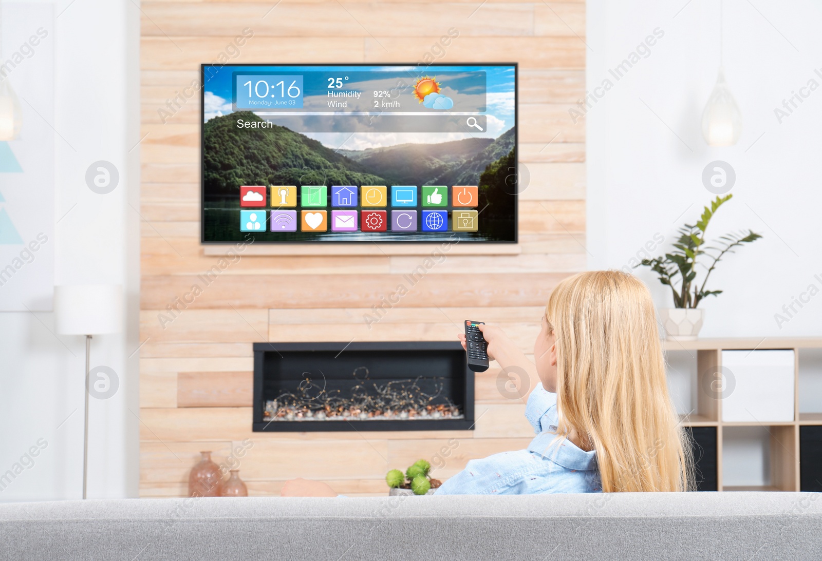 Image of Woman watching smart TV in living room