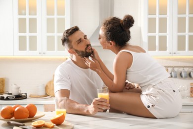 Photo of Lovely couple enjoying time together during breakfast at table in kitchen