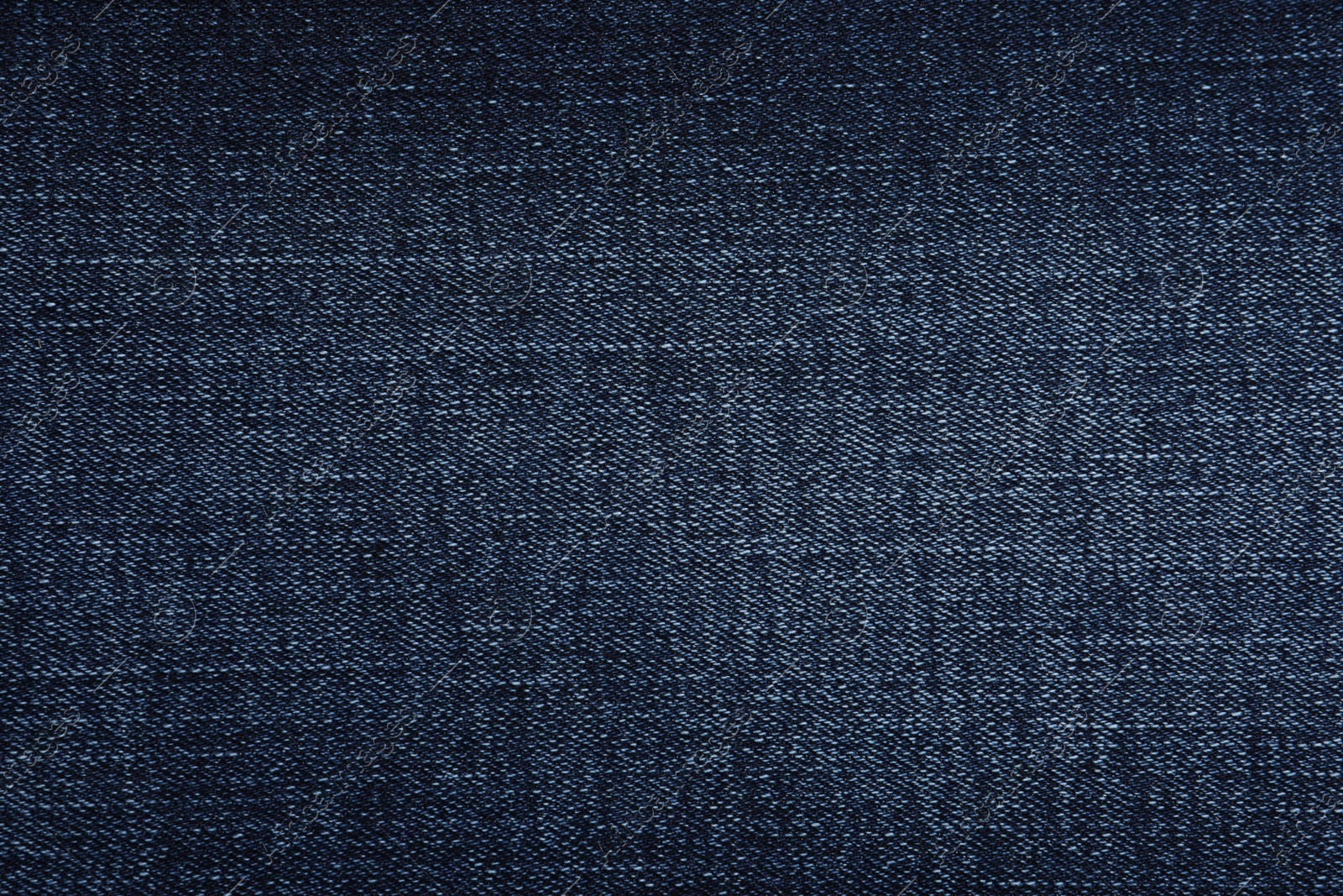 Photo of Texture of dark blue jeans as background, closeup