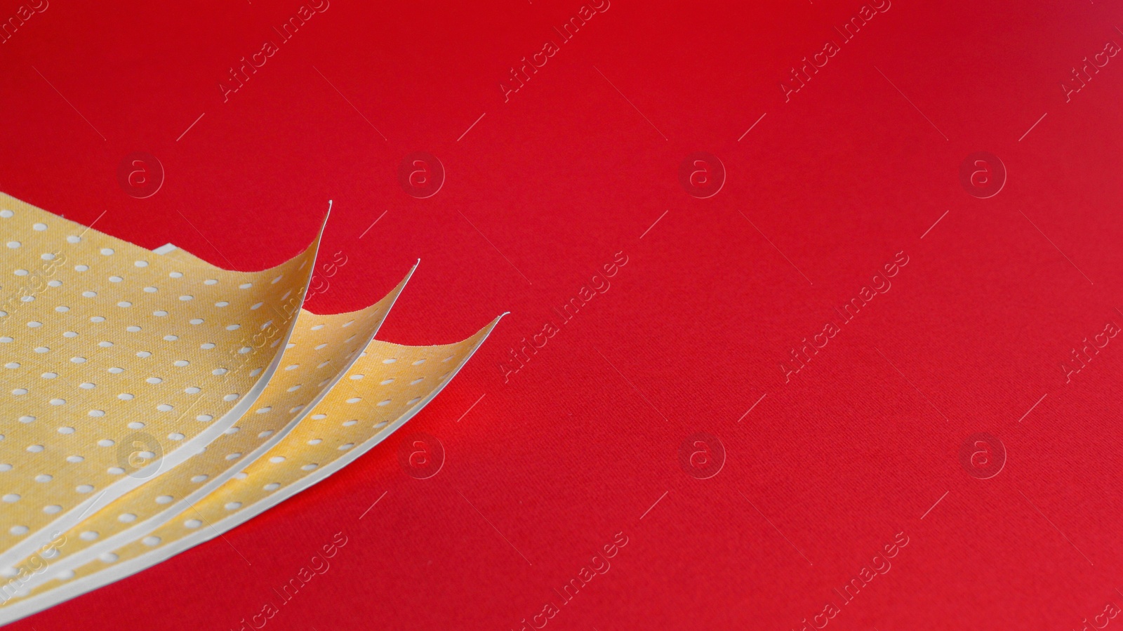 Photo of Pepper plasters on red background, space for text. Alternative medicine