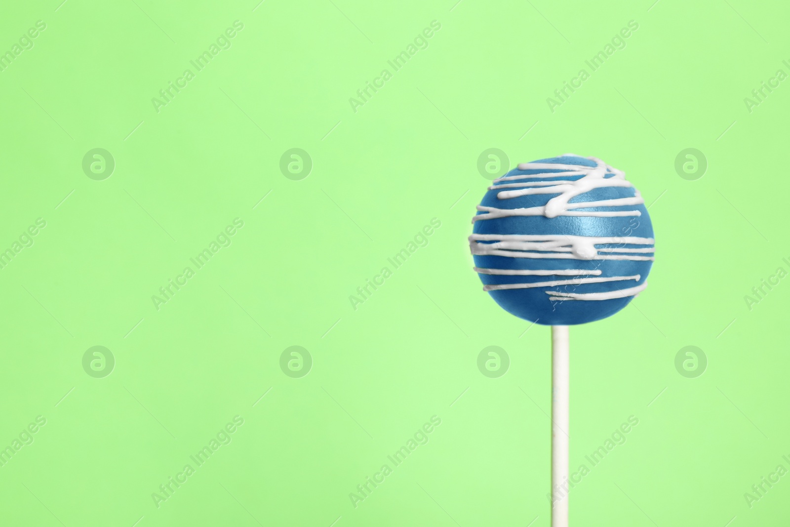 Photo of Bright delicious cake pop on color background. Space for text