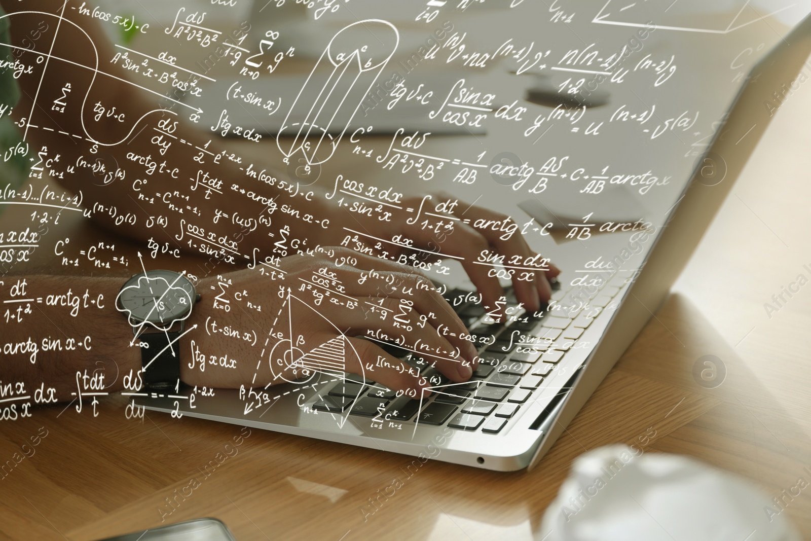 Image of Science and education concept. Illustration of basic physics and mathematics formulas and man working on laptop at table, closeup