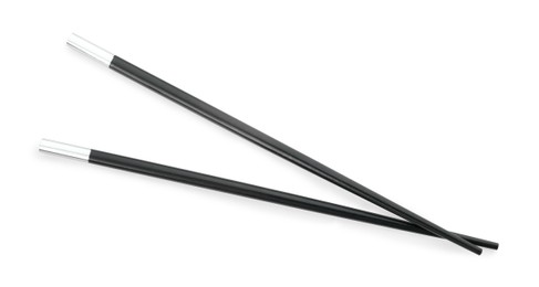 Photo of Pair of black chopsticks isolated on white, top view