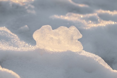 Photo of Snow with piece of ice outdoors on sunny day. Winter weather
