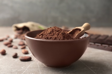 Photo of Bowl with cocoa powder on table